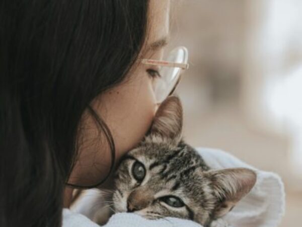 girl hugging cat